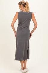 woman wearing a gray sleeveless maternity dress with a side slit, showing the back view