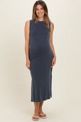 woman wearing a navy blue sleeveless maternity dress with a side slit and a visible baby bump