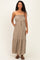woman wearing a khaki strapless maternity maxi dress with an elastic bodice and tie waist, featuring pockets