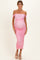 woman wearing a pink off-shoulder ruched maternity dress with a visible baby bump