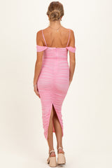 woman wearing a pink off-the-shoulder ruched maternity dress with a slit at the back