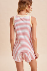 woman wearing a pink and white striped tank top and matching shorts, shown from the back