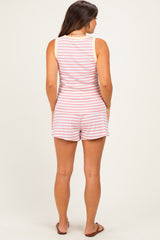 woman wearing a striped maternity romper with a sleeveless design, showing the back view