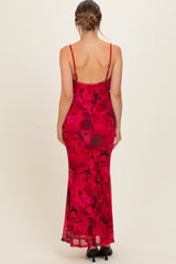 woman wearing a red floral maternity dress with a fitted silhouette and spaghetti straps