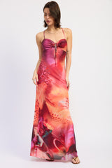 woman wearing a pink and purple tie-dye maxi dress with a ruched bodice and spaghetti straps