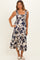 woman wearing a floral print maternity dress with tiered skirt and ruffled straps, casual summer style