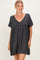 woman wearing a dark gray short sleeve tunic dress with a v-neck and gathered waistline