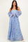 woman wearing a light blue floral off-shoulder maxi dress with puffy sleeves and a flowing skirt
