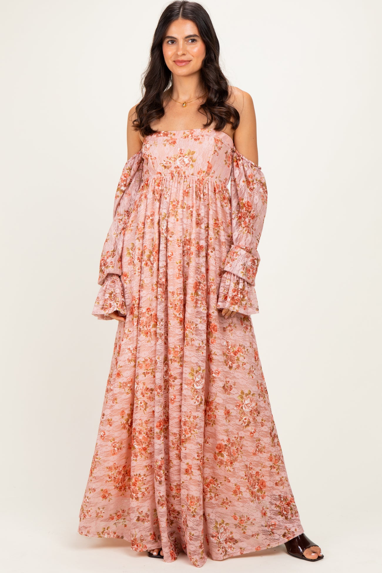 woman wearing a pink floral off-the-shoulder maxi dress with puffed sleeves and a relaxed fit