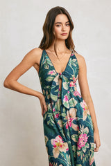 woman wearing a navy floral maxi dress with a tie front and spaghetti straps