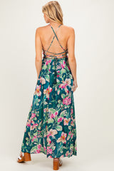 woman wearing a floral print maternity maxi dress with a crisscross back and flowing skirt