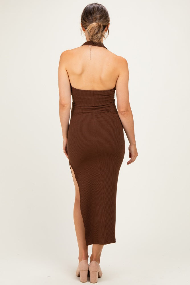 woman wearing a brown ribbed maternity dress with a side slit, showing a pregnant baby bump from the back