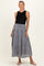woman wearing a black sleeveless top and a long tiered gray maternity skirt with a tie waist