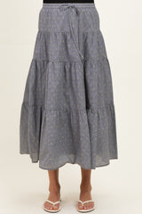maternity wear gray tiered maxi skirt with gold stripes and drawstring waist, worn by a model standing in sandals