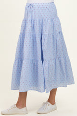 maternity wear light blue tiered maxi skirt with red dot pattern, worn with white sneakers