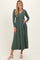 woman wearing a dark green ribbed maxi dress with long sleeves and button details