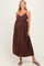 woman wearing a brown maternity maxi dress with adjustable straps and a flowy fit, baby bump visible