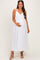 woman wearing a white maternity maxi dress with spaghetti straps and holding her baby bump