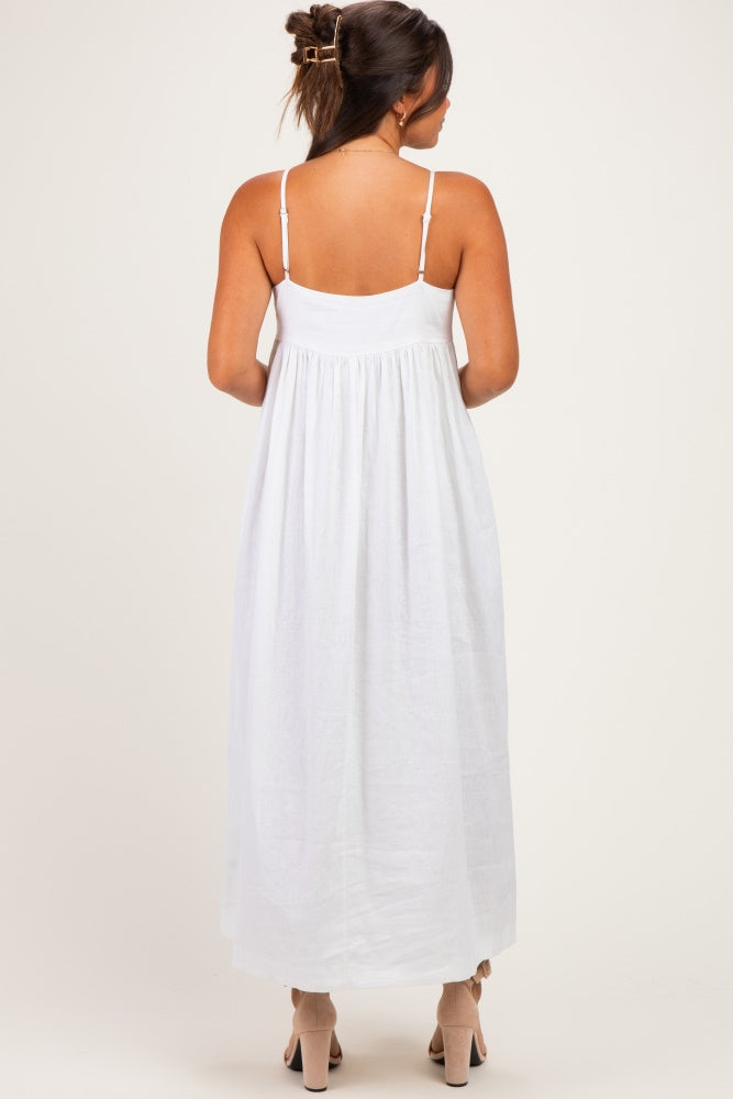 woman wearing a white maternity maxi dress with adjustable straps, showing the back view