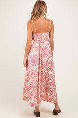 woman wearing a floral print maternity maxi dress with adjustable straps and a smocked back, showing a relaxed fit