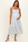 woman wearing a light blue striped maternity dress with a tiered design and holding her baby bump