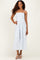 woman wearing a light blue striped maxi dress with spaghetti straps and a tiered ruffle design