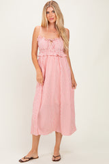 woman wearing a red and white striped maxi dress with ruffle details and adjustable straps