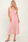 woman wearing a red and white striped maxi dress with ruffle details and adjustable straps