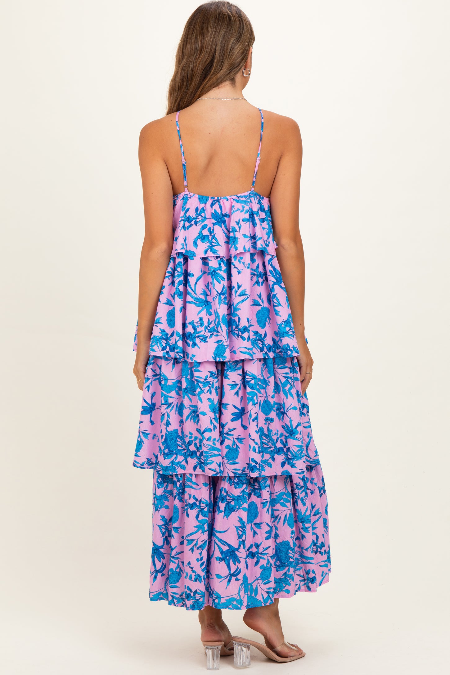 woman wearing a pink and blue floral maternity maxi dress with layered tiers and thin straps