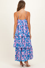 woman wearing a pink and blue floral maternity maxi dress with layered tiers and thin straps