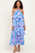 woman wearing a pink and blue floral tiered maxi dress with a halter neckline and ruffled details