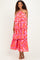 woman wearing a red floral tiered maxi dress with spaghetti straps and a flowy silhouette