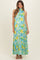 woman wearing a floral halter neck maxi maternity dress in shades of blue and yellow