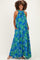 woman wearing a blue floral maternity maxi dress with halter neck and pockets