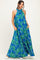 woman wearing a halter neck blue floral maxi dress with pockets