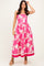 woman wearing a strapless pink floral maxi dress with a fitted bodice and flared skirt
