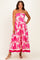 woman wearing a strapless pink floral maternity dress with a flowy skirt and a tiered hem