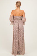 woman wearing a mauve off-the-shoulder maxi dress with long bell sleeves and a fitted waist