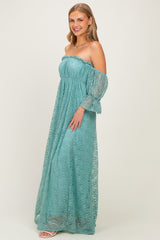 woman wearing a teal off-the-shoulder lace maxi dress with long flared sleeves