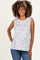 woman wearing a floral sleeveless maternity top with a relaxed fit and baby bump visible, paired with blue jeans
