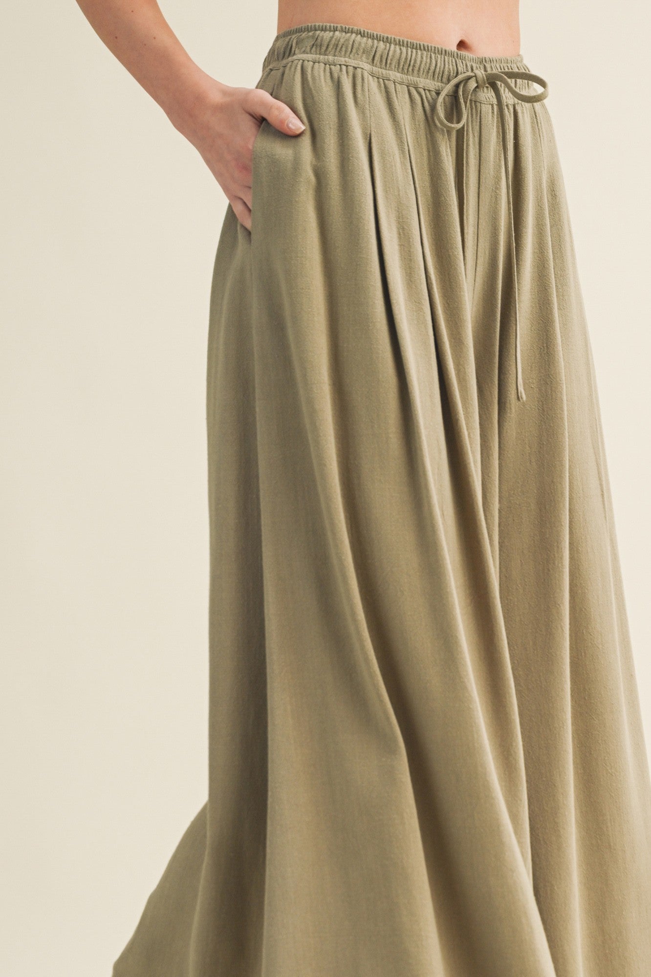 woman wearing a khaki long maxi skirt with an elastic waistband and side pockets