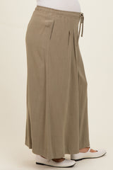 maternity wear in khaki wide leg pants with an elastic waistband and drawstring, featuring pleats and a visible baby bump