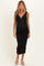 woman wearing a black ribbed maternity dress with a v-neckline and a visible baby bump