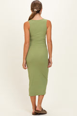 woman wearing a ribbed olive green maternity midi dress, showing the back view