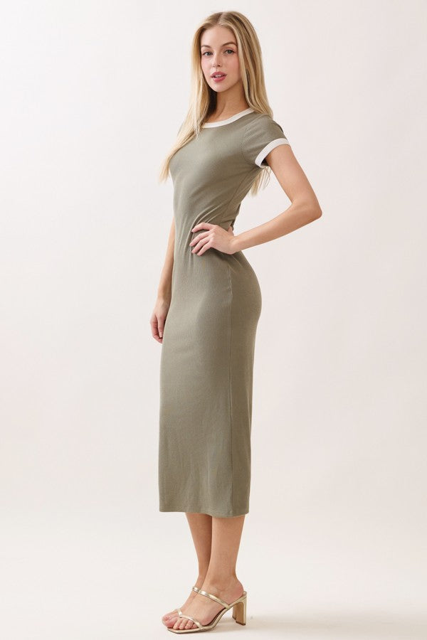 woman wearing a fitted olive green t-shirt dress with white sleeve detailing and high heels