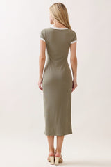 woman wearing a fitted olive green midi dress with white trim and short sleeves, shown from the back