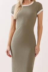woman wearing a fitted olive green ribbed t-shirt dress with white trim on the sleeves and neckline