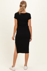 woman wearing a black maternity midi dress with a side slit, viewed from the back