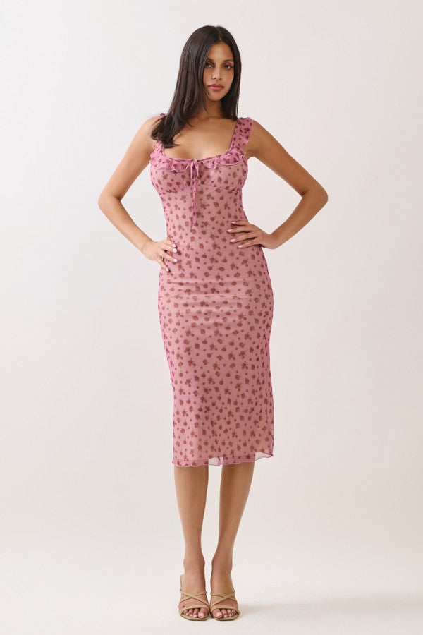 woman wearing a pink floral slip dress with adjustable straps and a fitted silhouette