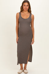 woman wearing a black and white striped maternity maxi dress with a side slit